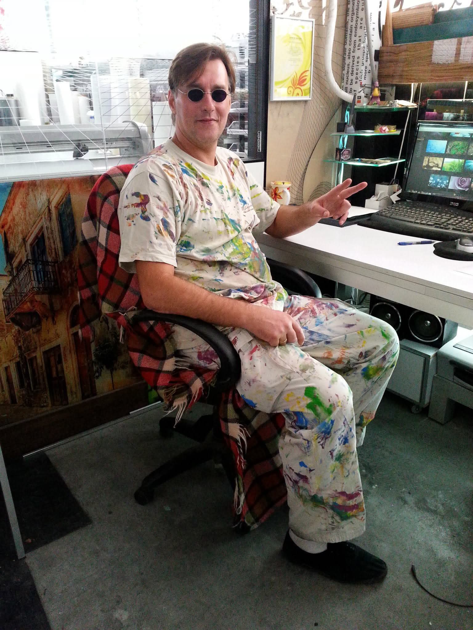 The artist seated in the workshop